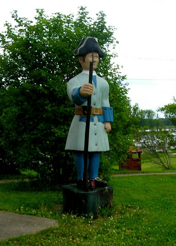 Wooden statue on the Oromocto waterfront, highlighting the town's military heritage.