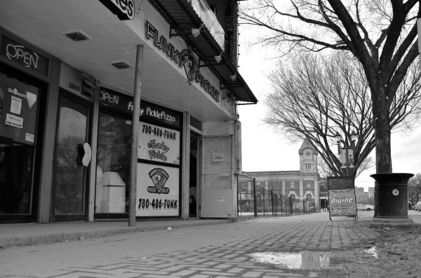 2013 - Retail building with adjacent empty lot and Post Office in background. 