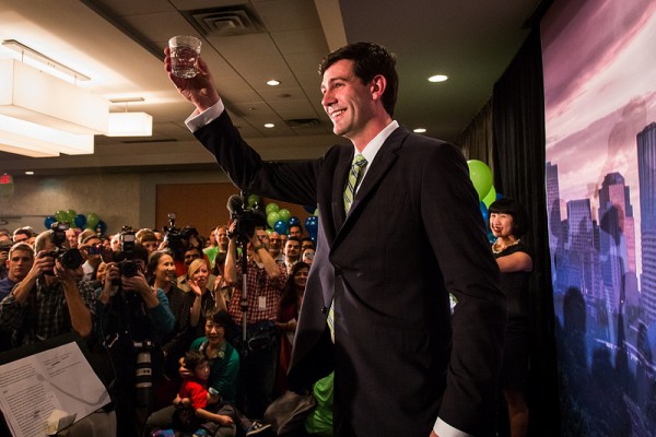 A quick glass of "Edmonton's finest" mid-speech while his wife Sarah looks on.