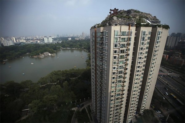 In Beijing, an illegal mountain was built atop a 26 story high-rise