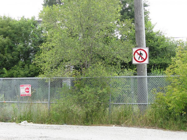 Reinforced fencing to prevent a logical pedestrian crossing, at the end of Bridgeland Road in North York.