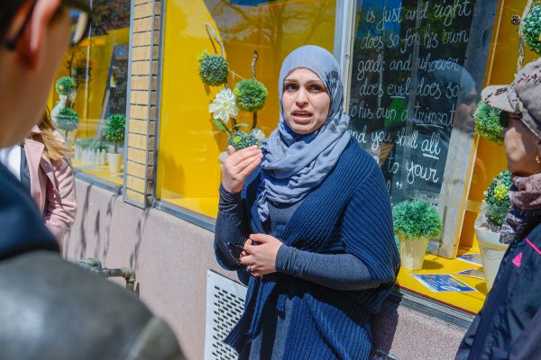 Community organizer Rusul Alrubail stands in front of the Toronto Dawah Centre's storefront display to share her story about the White Ribbon Campaign.