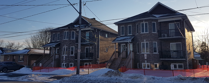 A pair of recently built, infill triplexes. While larger than the neighbouring bungalow, they would not be out of scale in most neighbourhoods of single detached homes.