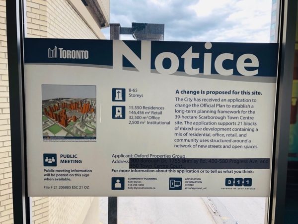 A development application notice on the skybridge from Line 3 to Scarborough Town Centre