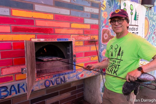 Volunteer Dale Howey bakes scones in Regent Park’s outdoor oven