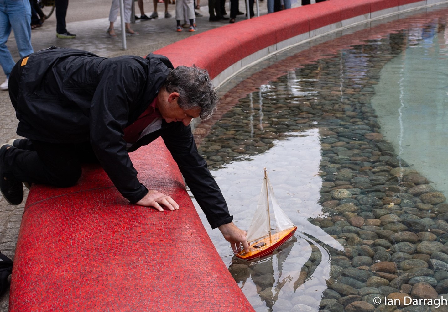 Launching a sailboat on Love Park pond.