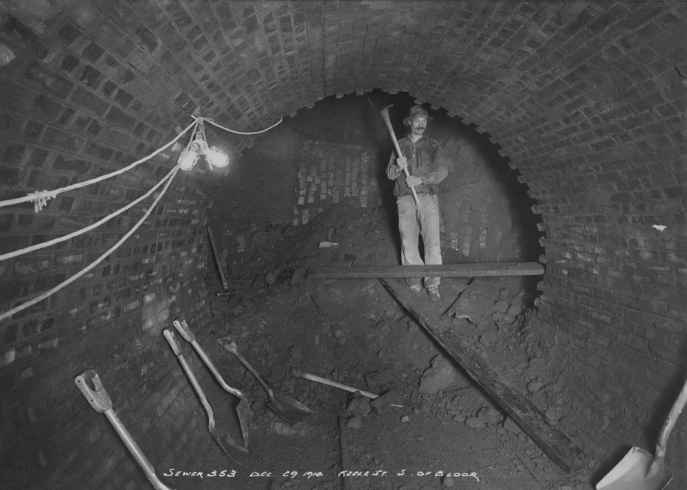 Worker in sewer under construction