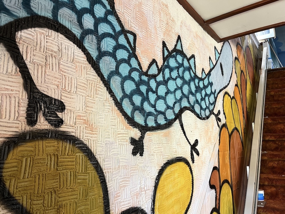 A playful dragon by the emerging muralist Catchoo.