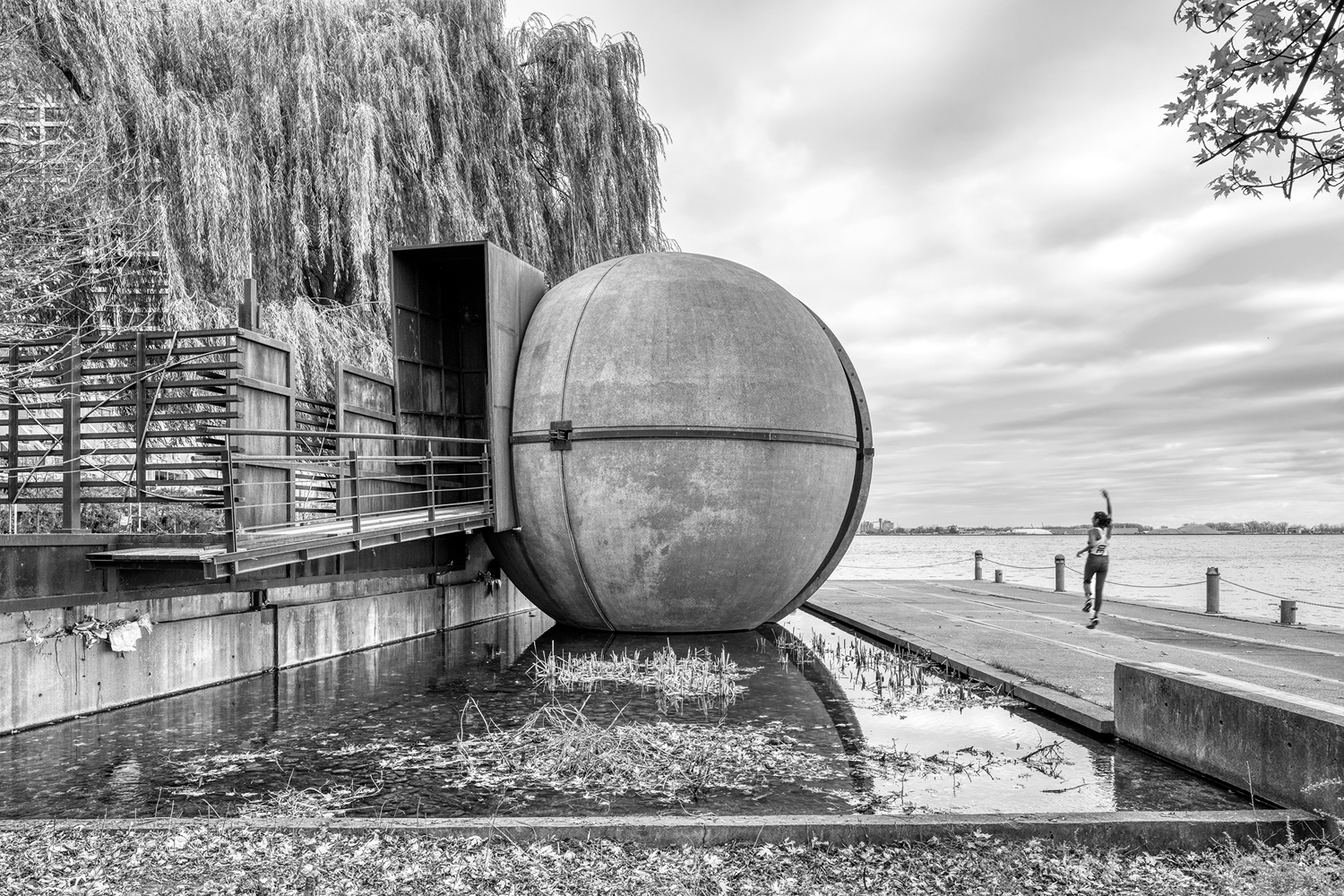 The Sundial Folly, a steel and concrete sculpture located on the southwest corner of Harbour Square Park. The giant steel globe by John Fung and Paul Figueiredoreposes in a pool of water that feeds an adjacent waterfall spilling into Lake Ontario. Visitors can enter the globe from a ramp on one side for a unique view of Lake Ontario.