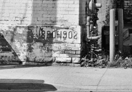 Closeup of cornerstone bearing the hyphenated dates 1880-1902