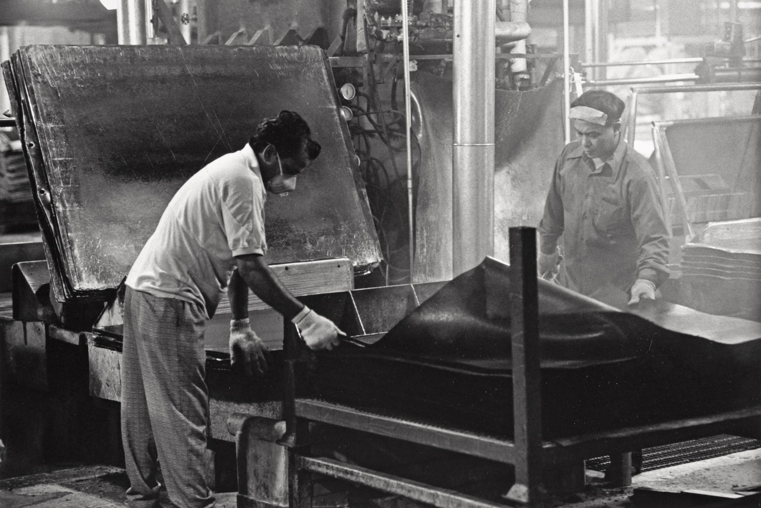 Balbar Gill and Hang-Ji Hi unloading a sheet press, Department 51, September, 1993