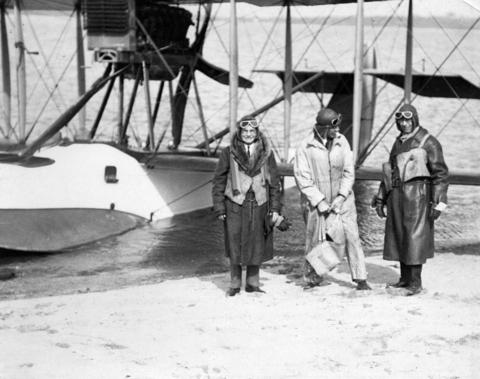 Cpn. Glover, Major MC, and Mayor Taylor in front of a flying boat at Jericho.