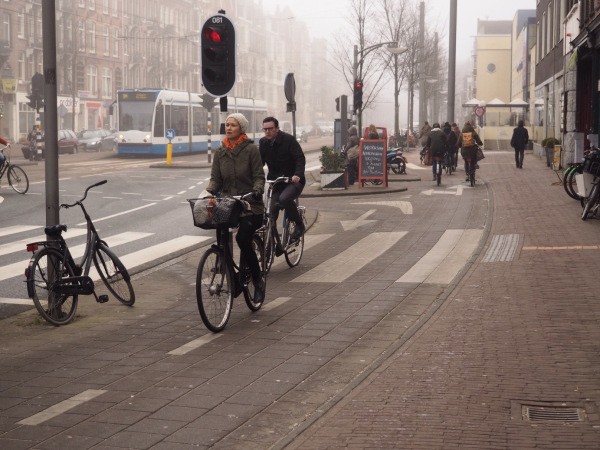 An attractive retail complete street with two bi-directional bike lanes, generous sidewalks, two lanes of trams and several vehicular lanes.