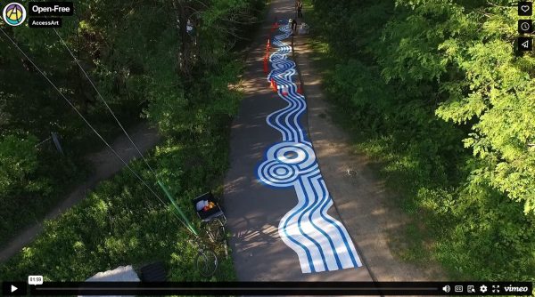 Clip from video, showing multi-use trail decorated with painting on the surface