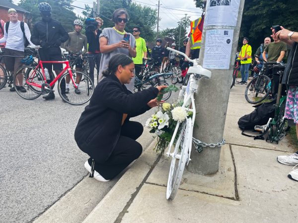 Cyclists placing ghost bike