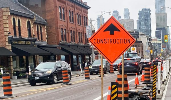 Cars on street, with construction sign