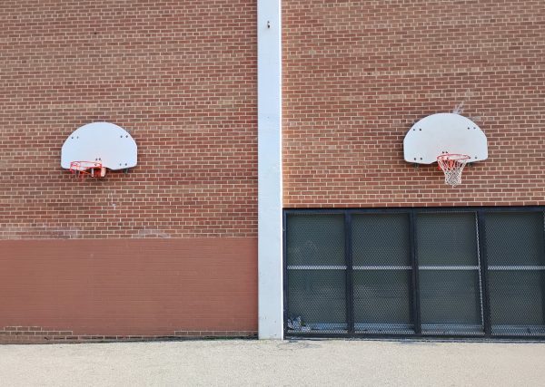 Basketball hoops on a school exterior wall