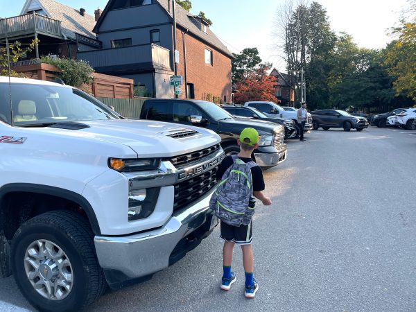 Child in front of pickup truck