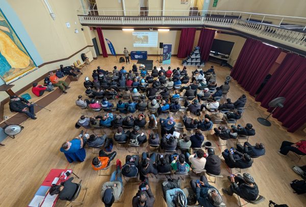 People in a room watching a presentation